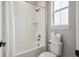 Bathroom featuring a tiled tub and shower combo, a window, and toilet at 359 Rogers Way, Castle Rock, CO 80104