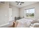 Bright bedroom with a ceiling fan, large window, and stylish metal-frame bed at 359 Rogers Way, Castle Rock, CO 80104