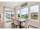 Bright dining area with large windows, hardwood floors, and stylish furniture. Views of the outdoors at 359 Rogers Way, Castle Rock, CO 80104