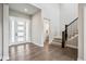 Bright foyer with hardwood floors, statement staircase, and modern front door at 359 Rogers Way, Castle Rock, CO 80104