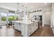 Gourmet kitchen with oversized island, granite countertops, stainless appliances, and hardwood floors at 359 Rogers Way, Castle Rock, CO 80104