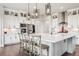 Bright kitchen with a large island, modern appliances, stylish pendant lights, and ample storage at 359 Rogers Way, Castle Rock, CO 80104