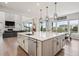 Spacious kitchen features a large island with modern appliances and stylish pendant lighting at 359 Rogers Way, Castle Rock, CO 80104