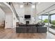 Open-concept living room with vaulted ceilings, fireplace, and access to outdoor patio at 359 Rogers Way, Castle Rock, CO 80104