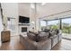 Light-filled living room with hardwood floors, fireplace, and sliding glass doors to the patio at 359 Rogers Way, Castle Rock, CO 80104