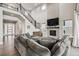 Sophisticated living room with fireplace, tall ceilings, hardwood floors, and lots of natural light at 359 Rogers Way, Castle Rock, CO 80104