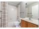 Clean bathroom with a shower-tub combination, toilet, and wooden vanity at 1521 Vine St # 108, Denver, CO 80206