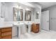 Bathroom with double vanity sinks, large mirrors, and tile flooring at 1521 Vine St # 108, Denver, CO 80206