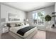 Staged bedroom featuring a large window, contemporary decor, and a neutral color palette at 1521 Vine St # 108, Denver, CO 80206