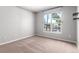 Bedroom with large window providing natural light and carpet floors at 1521 Vine St # 108, Denver, CO 80206