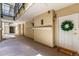 Well-lit building hallway with multiple entry doors and a decorative wreath at 1521 Vine St # 108, Denver, CO 80206