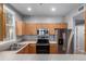 Modern kitchen with stainless steel appliances, ample counter space, and wood cabinetry at 1521 Vine St # 108, Denver, CO 80206