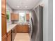 U-shaped kitchen with stainless steel appliances and wood cabinets at 1521 Vine St # 108, Denver, CO 80206