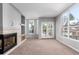 Light-filled living room features a fireplace and a balcony overlooking the neighborhood at 1521 Vine St # 108, Denver, CO 80206