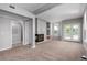 Airy living area boasts fireplace, neutral carpet, and access to balcony with double doors at 1521 Vine St # 108, Denver, CO 80206