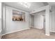 Open-concept living room featuring neutral tones, carpet, and pass-through to the kitchen at 1521 Vine St # 108, Denver, CO 80206