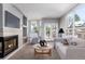 Bright living room features a fireplace, plush carpet, and a balcony with views at 1521 Vine St # 108, Denver, CO 80206