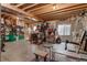 Unfinished basement features exposed wood ceiling, concrete floor, and ample space for storage and fitness at 2912 Lake Park Way, Longmont, CO 80503