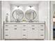 Elegant bathroom with double vanity, round mirrors, and modern fixtures at 5557 E Links Cir, Centennial, CO 80122