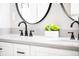 Bathroom vanity with double sinks, matte black faucets, and a gray countertop at 5557 E Links Cir, Centennial, CO 80122