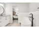 Stylish bathroom with a freestanding tub, vanity with quartz counters, and modern hardware at 5557 E Links Cir, Centennial, CO 80122