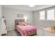 Bright bedroom featuring carpet, a colorful bed, and ample natural light from two windows at 5557 E Links Cir, Centennial, CO 80122
