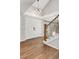 Welcoming foyer features hardwood floors, a staircase with iron railings, and modern lighting fixture at 5557 E Links Cir, Centennial, CO 80122