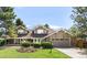 Charming two-story home featuring a well-manicured lawn, stone accents, and an attached two-car garage at 5557 E Links Cir, Centennial, CO 80122