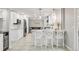 Lovely kitchen featuring a breakfast bar, white cabinetry, stainless steel appliances, and adjacent dining area at 5557 E Links Cir, Centennial, CO 80122