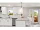 Modern kitchen design with breakfast bar seating, quartz countertops, stainless steel appliances and bright window at 5557 E Links Cir, Centennial, CO 80122
