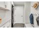 Functional laundry room equipped with modern washer/dryer units and convenient storage at 5557 E Links Cir, Centennial, CO 80122