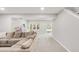 Bright living room with plush carpeting, large windows, and a walkout to the backyard at 5557 E Links Cir, Centennial, CO 80122