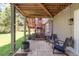 Covered patio area with lounge seating and an outdoor fire pit at 5557 E Links Cir, Centennial, CO 80122