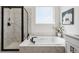 Well-lit bathroom with luxurious soaking tub, walk-in shower, and marble surround at 42979 Colonial Trl, Elizabeth, CO 80107