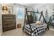bedroom with custom tent-style bed, decorative wallpaper, and natural light at 42979 Colonial Trl, Elizabeth, CO 80107