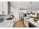 Modern kitchen with stainless steel appliances, eat in island, and white cabinets at 42979 Colonial Trl, Elizabeth, CO 80107