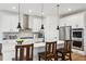 Modern kitchen with stainless steel appliances, island seating, and stylish pendant lighting at 42979 Colonial Trl, Elizabeth, CO 80107