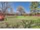 Large backyard with trees, lawn and fencing on a sunny day at 907 Stein St, Lafayette, CO 80026