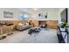 Finished basement with carpet flooring, wood paneled accent wall, modern furnishings, and natural light from the window at 907 Stein St, Lafayette, CO 80026
