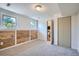 Finished basement featuring wood paneled accent wall, carpet flooring, and natural light from the windows at 907 Stein St, Lafayette, CO 80026
