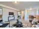 Basement living room featuring carpet flooring, wood paneled accent wall, and modern furnishings, including a large TV at 907 Stein St, Lafayette, CO 80026