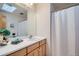 Bathroom featuring a large mirror, vanity and shower with white curtain at 907 Stein St, Lafayette, CO 80026