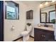 Cozy bathroom featuring a dark wood vanity, granite countertops, and a classic toilet, offering a functional space at 907 Stein St, Lafayette, CO 80026