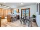 Sunny dining area with wood floors and sliding doors that leads to backyard at 907 Stein St, Lafayette, CO 80026