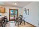 Cozy dining area with wood floors and sliding door that leads to backyard at 907 Stein St, Lafayette, CO 80026