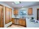 Bright kitchen featuring stainless steel appliances, a window overlooking the backyard, and ample cabinet space for storage at 907 Stein St, Lafayette, CO 80026