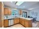 Sunlit kitchen featuring stainless steel appliances, countertops, and a breakfast nook with modern table and chairs at 907 Stein St, Lafayette, CO 80026