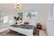 Cozy bedroom with a modern light fixture, window views, and a comfortable rug, creating a welcoming space at 11870 Tabor Dr, Lakewood, CO 80215