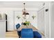 Bright dining area featuring a wooden table with blue velvet chairs and modern lighting fixtures at 209 Wright St # 204, Lakewood, CO 80228