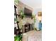 Stone fireplace with mounted TV, black iron fire screen, and plants adding to a cozy ambiance at 209 Wright St # 204, Lakewood, CO 80228
